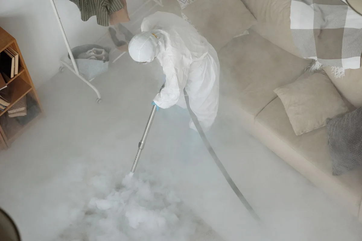 Biohazard cleanup technician in protective equipment, Lone Star, TX